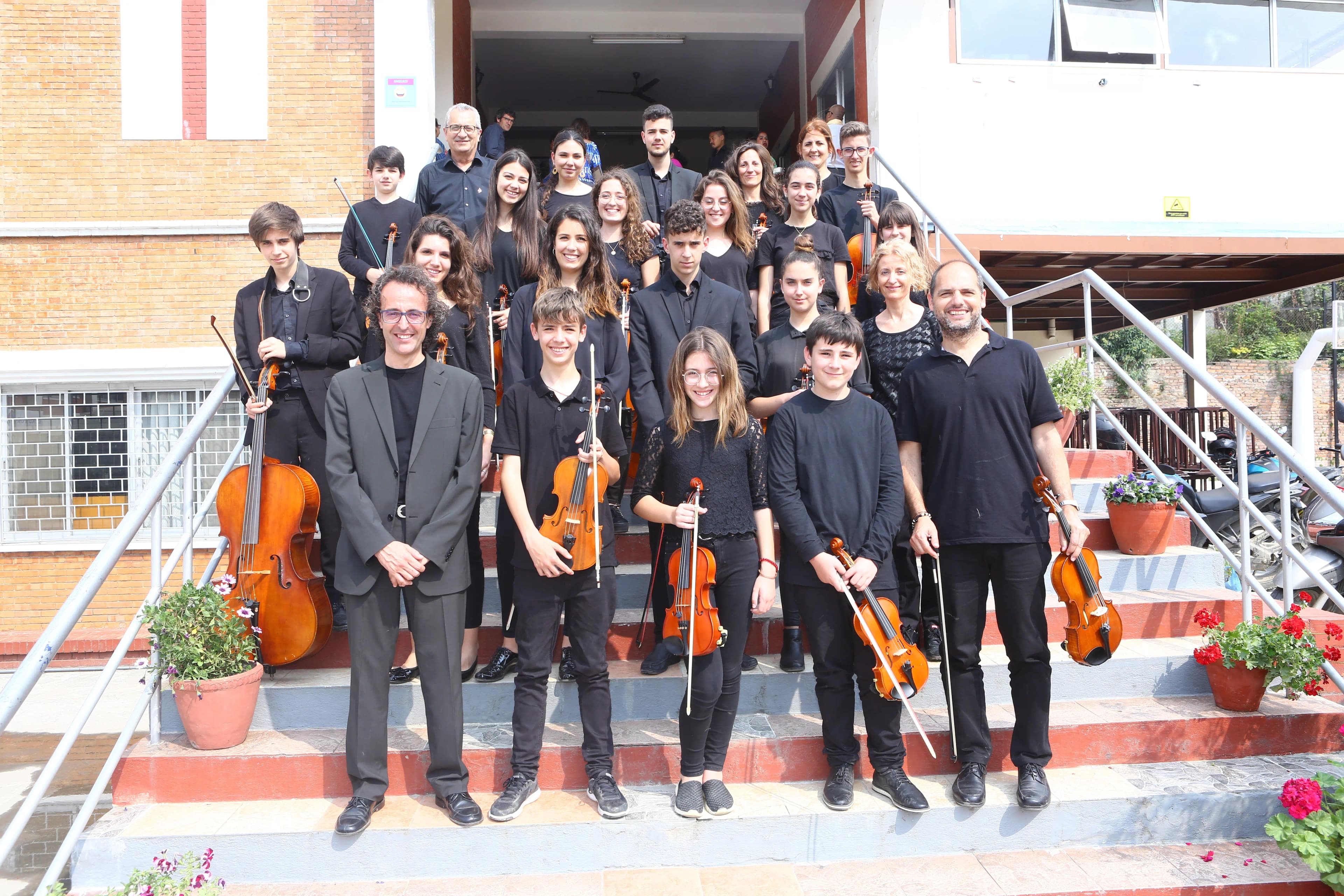 Around 23 - 26 members of Segon Temps - the orchestra band are posing in the staircase of Watrain hall of St. Xavier's College, Maitighar after performing at the Abhilasha - The Charity Orchestra Concert in Nepal.
