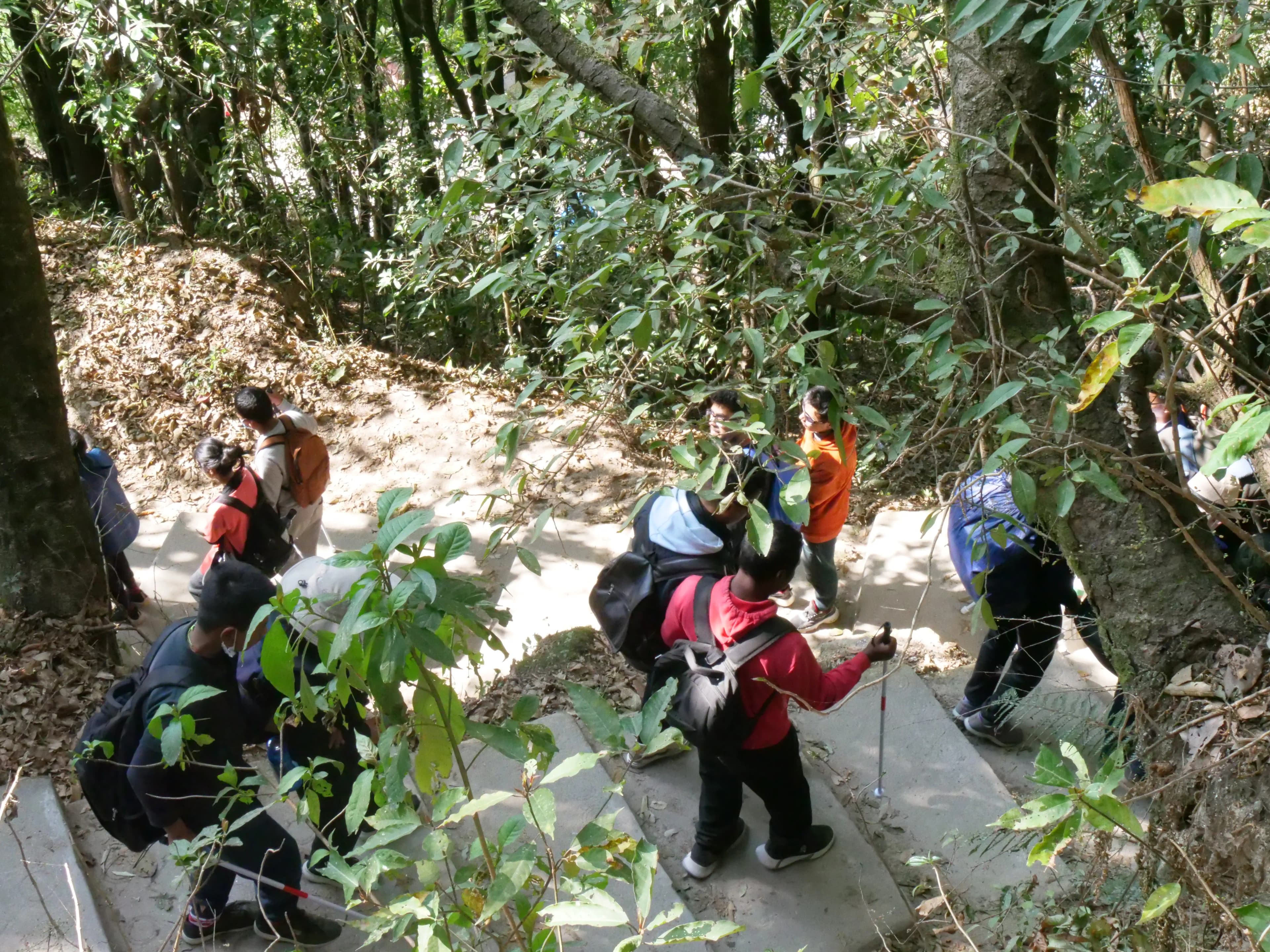 All the participants with and without visual disabilities are climbing down the staircase using the proper guiding techniques & mobility skills.