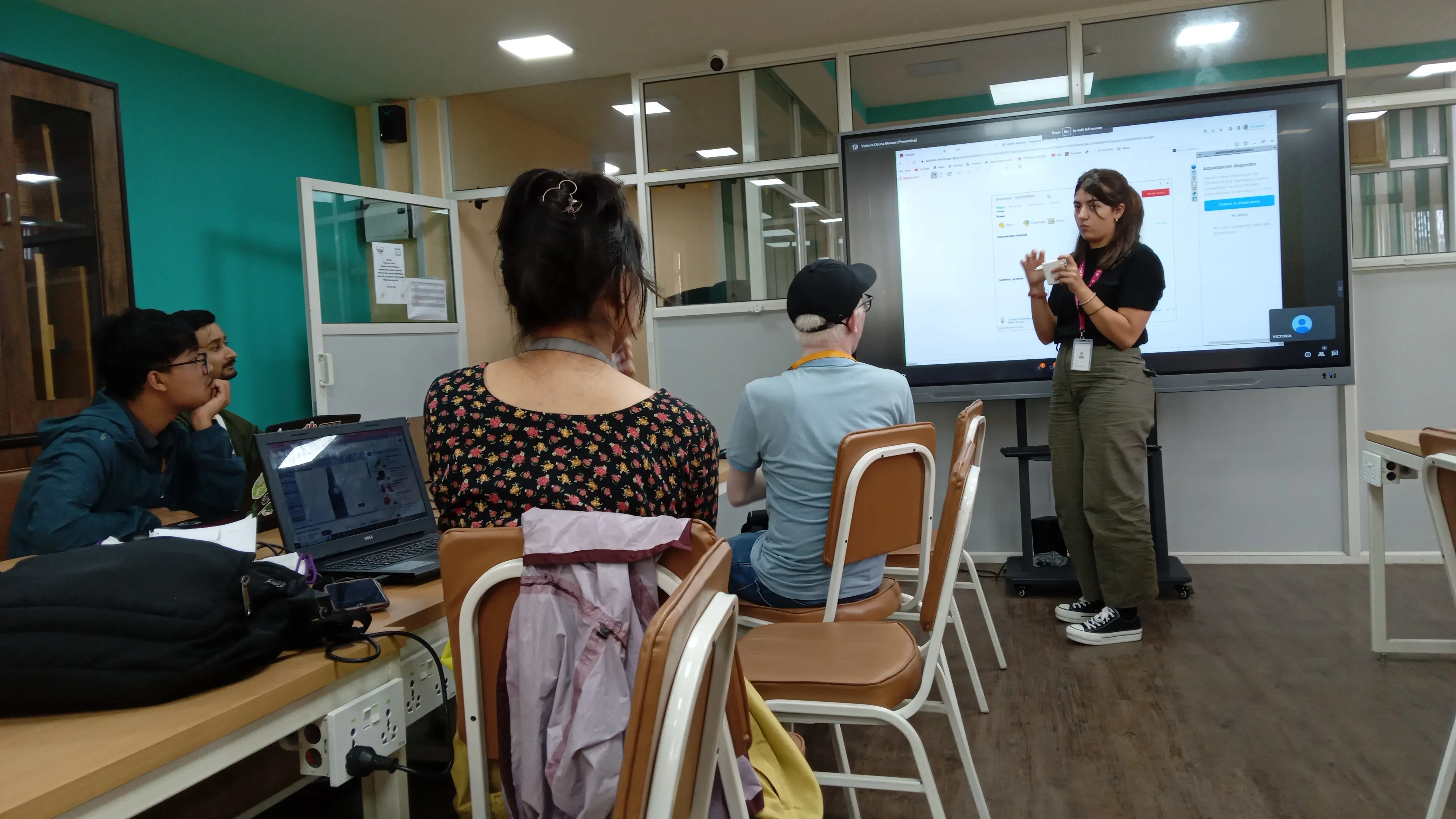 A picture where Victoria - the intern design instructor is speaking and 3D design team are carefully listening to her.