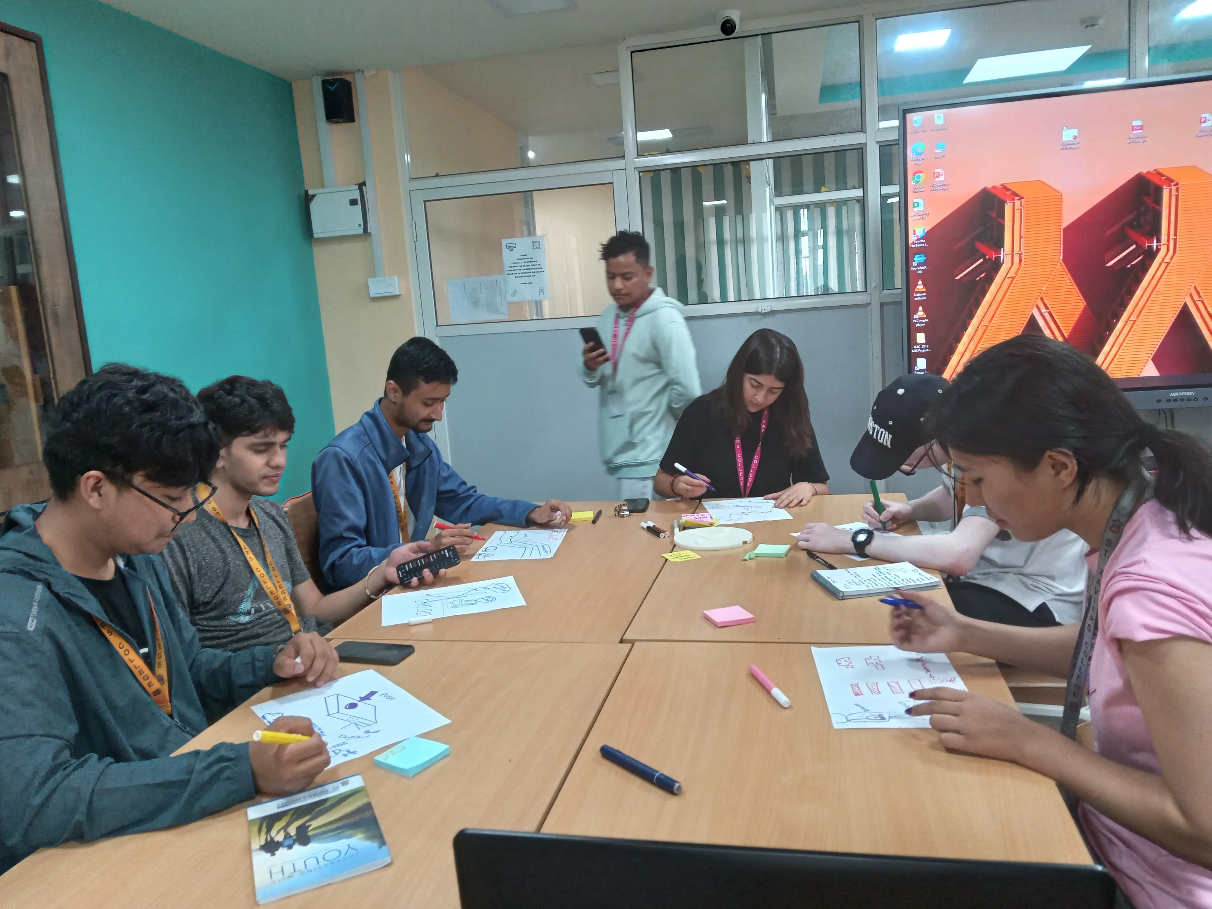 A picture where all the 3D designing team are sketching.