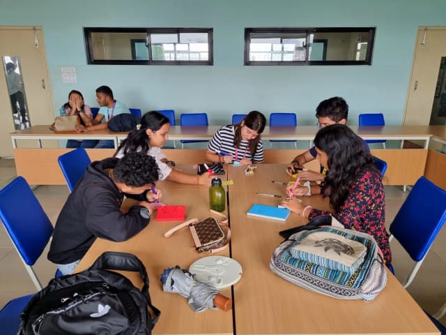 A picture where the dedicated team members are writing their ideas on the sticky notes.