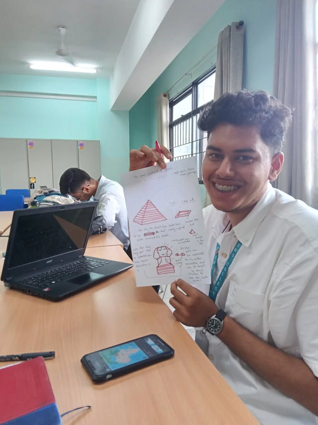A picture where one of the design team with locally available resources (Sangam Khadka) is posing with his concept.