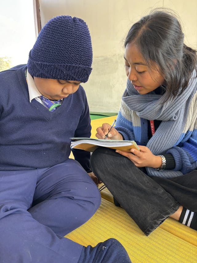 One of the project members Romee Jijicha is taking the pre-post assessment of a male child.