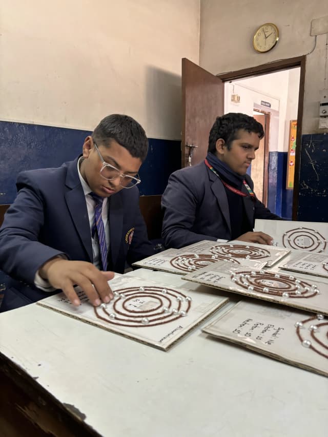 Two of the participants are observed perceiving 3D models of atomic structure.