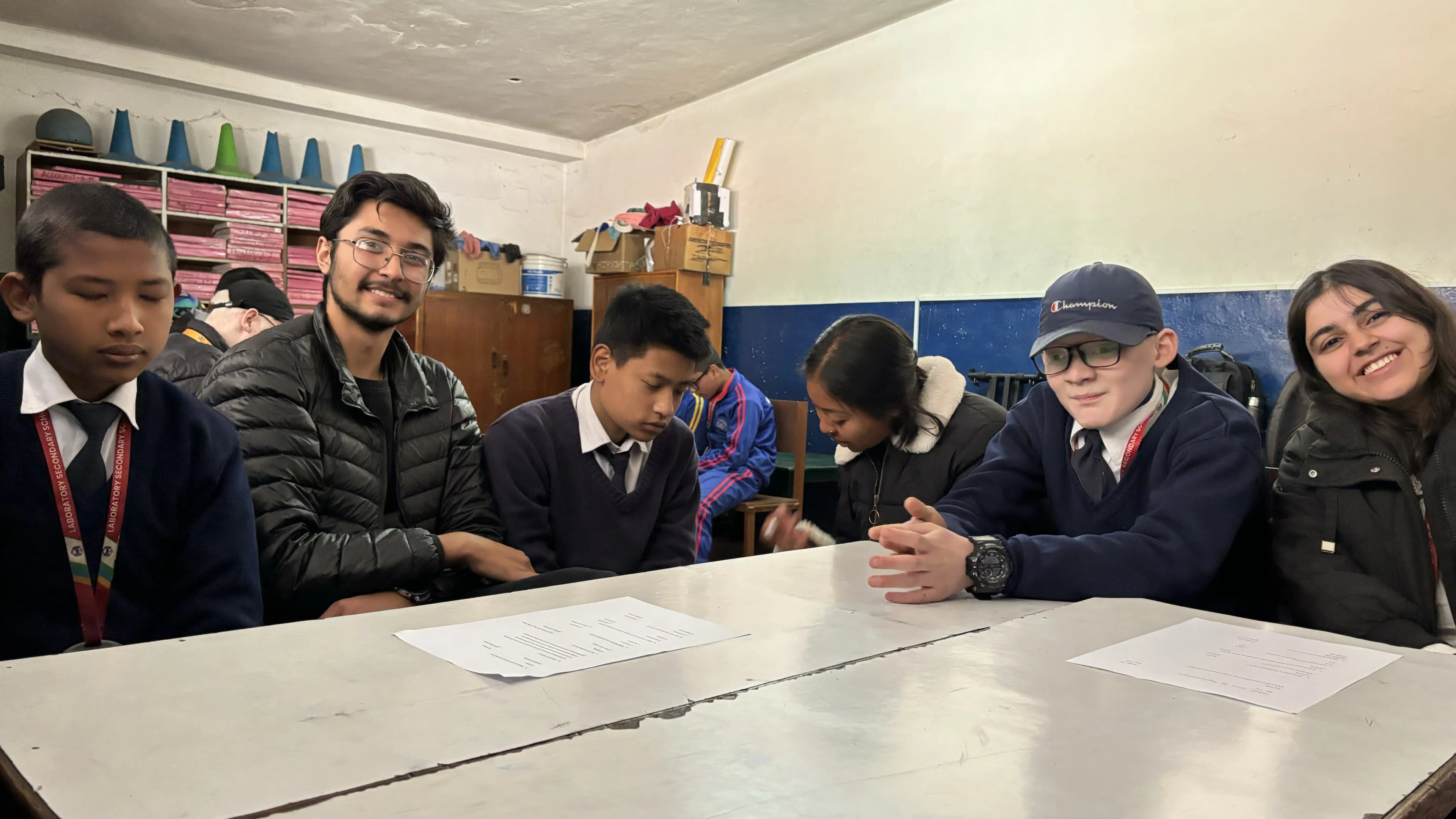 A group picture of 3 students and their respective supporting project members during the workshop.