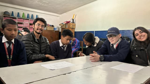 A group picture of 3 students and their respective supporting project members during the workshop.