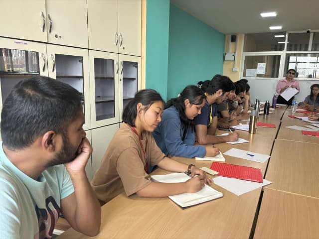 Facilitator Sabitri Poudel is explaining about Braille and fellow project members are noting down important points.