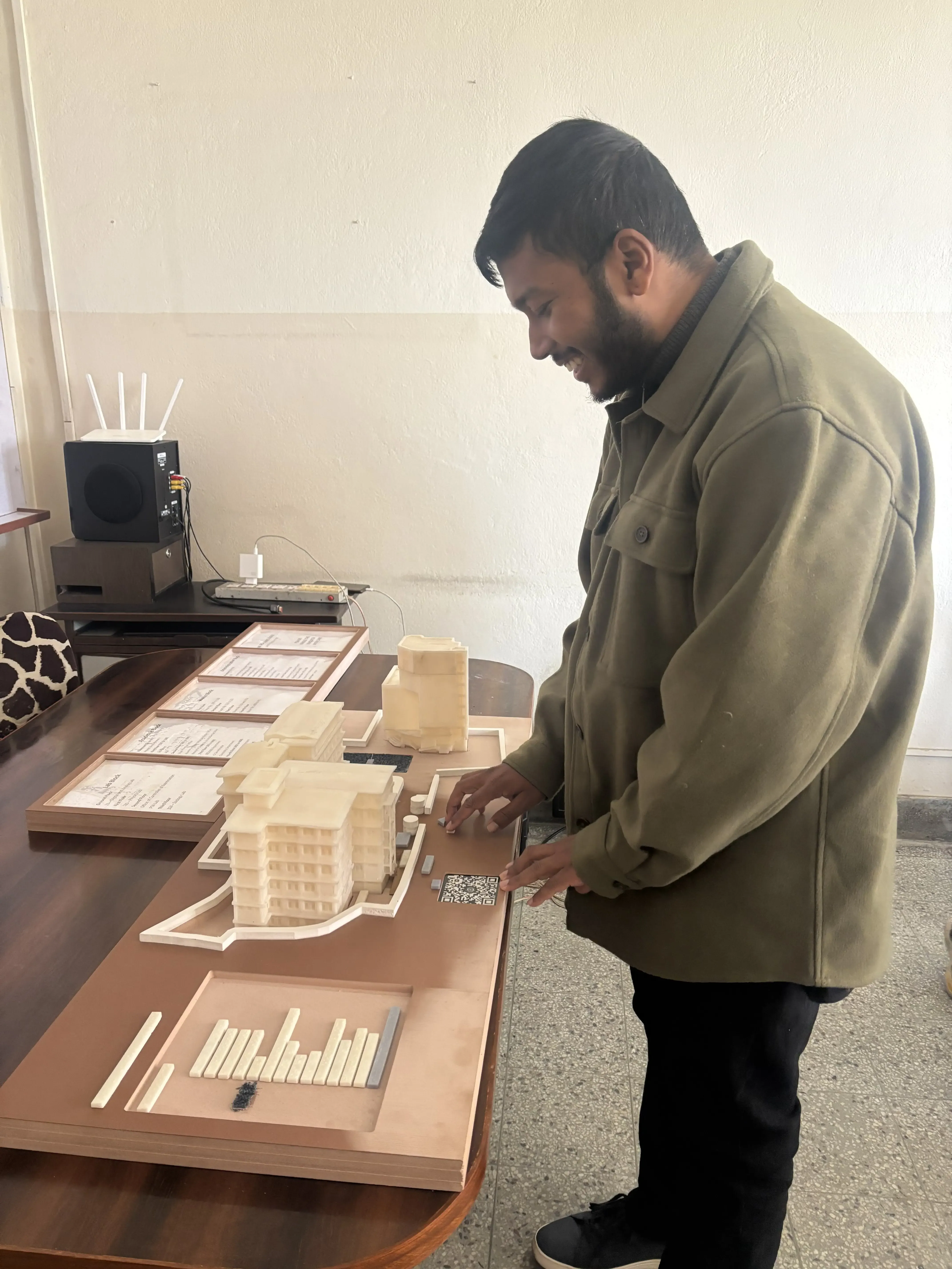 A picture of our Founder Abhishek Shahi touching the Maqueta of St. Xavier's College.