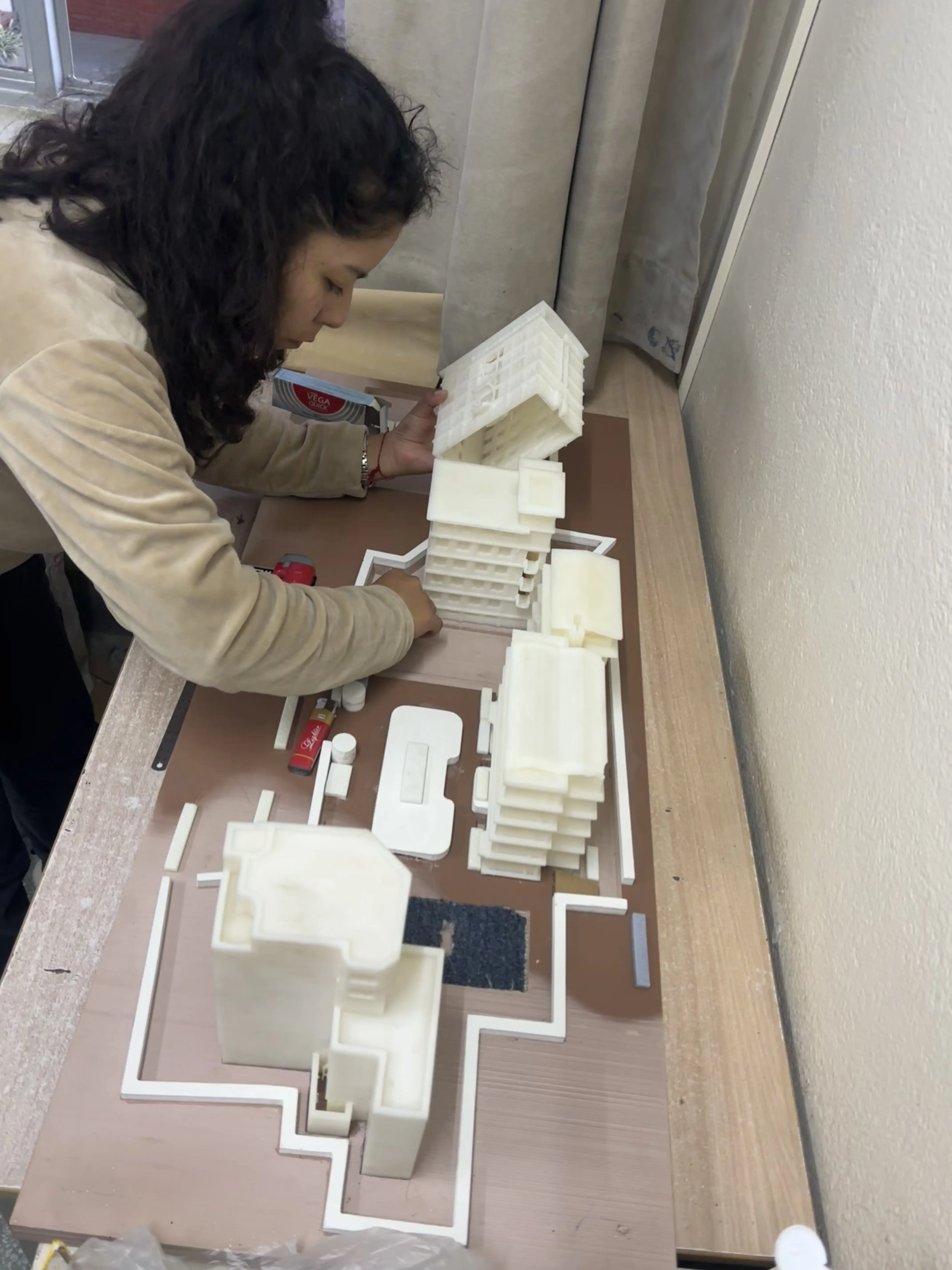 A picture of our Intern Architect for Accessibility (2024 - 2025) Ms. Katherine Gumiel Silva working on to complete the Maqueta of the St. Xavier's College.