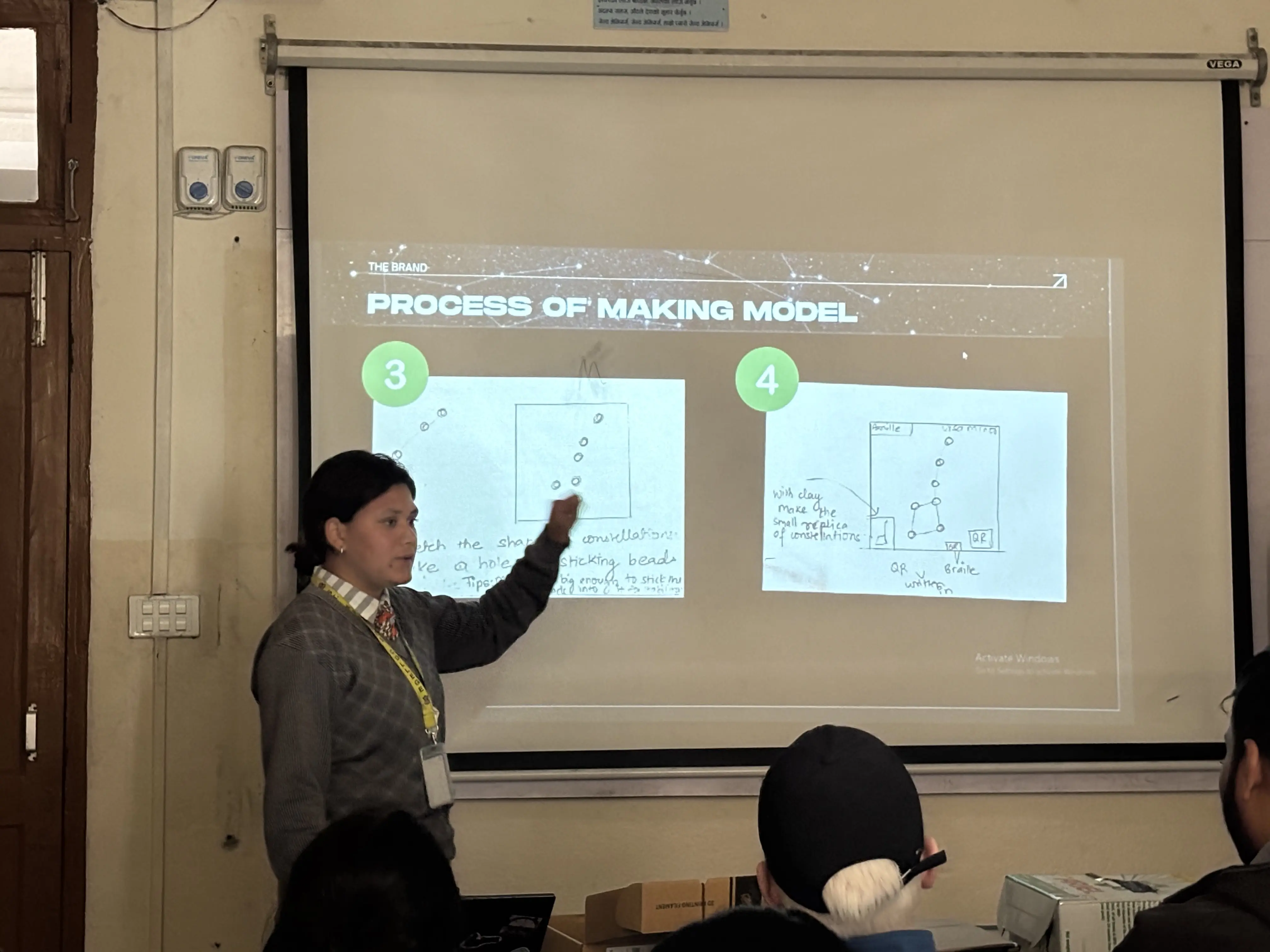 One of the project members, Anisha Roka is presenting about the process of making her model. In the background, sketch of process of making 3D model is being projected.