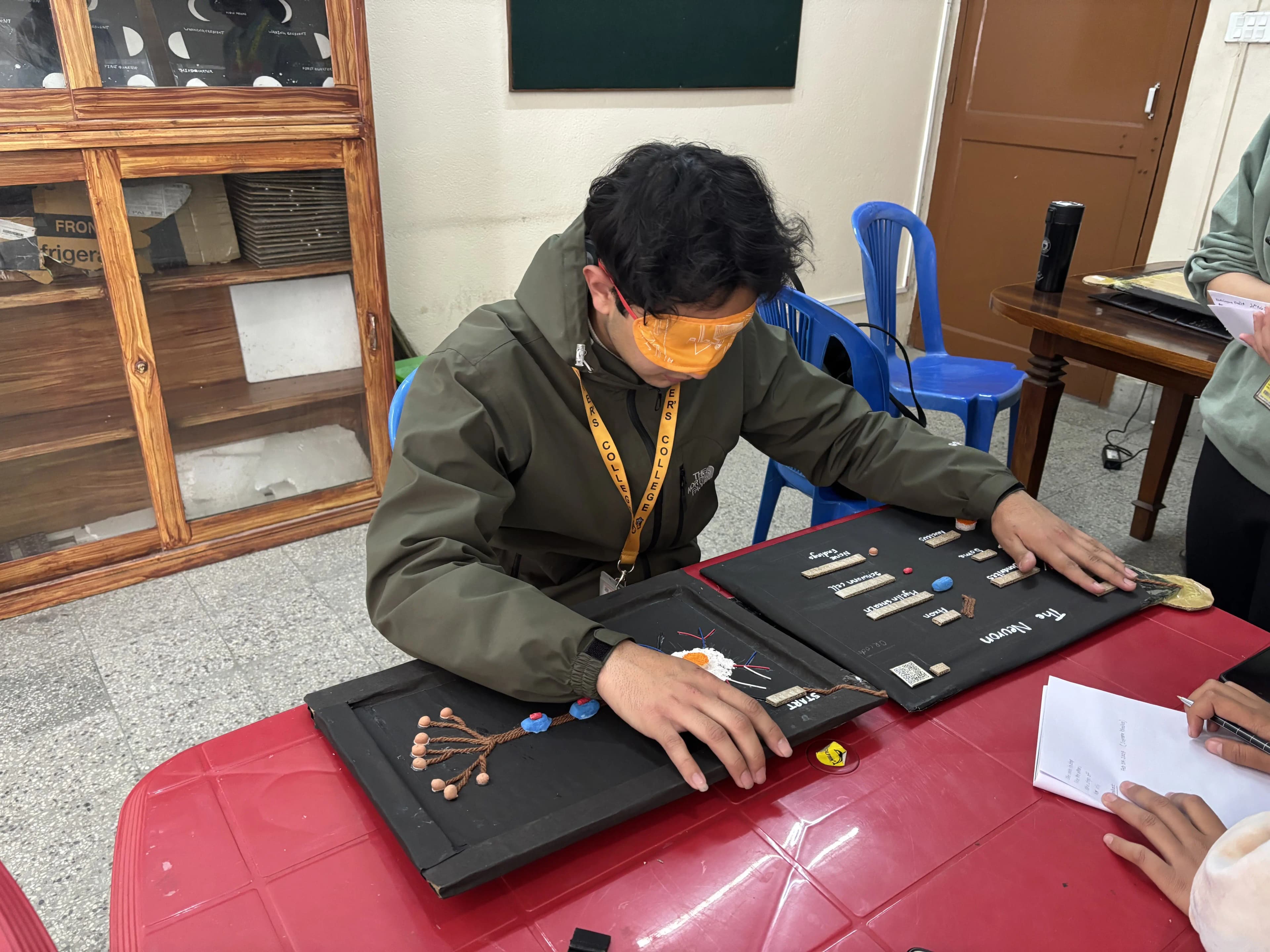 A picture where one of our project members, Supreme Khadka is exploring the 3D model of Neuron being blindfolded.
