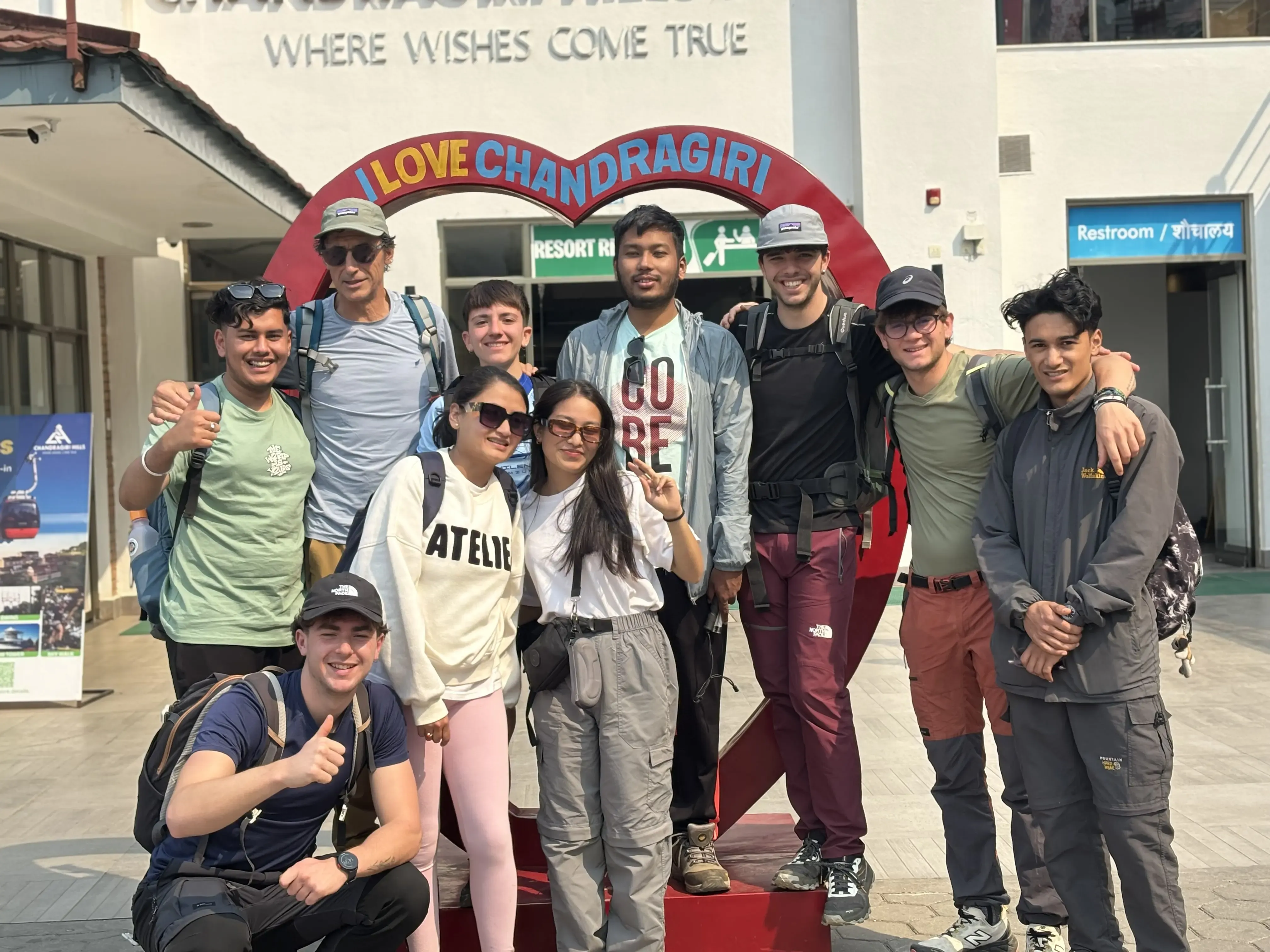 A group picture of 10 individuals including Mr. Alfonso Xosé González Cabarcos and his 4 Spanish students along with CFC members. In the background, there is a photo stand where it is written 'I love Chandragiri'.