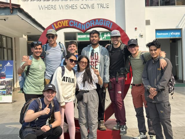 A group picture of 10 individuals including Mr. Alfonso Xosé González Cabarcos and his 4 Spanish students along with CFC members. In the background, there is a photo stand where it is written 'I love Chandragiri'.