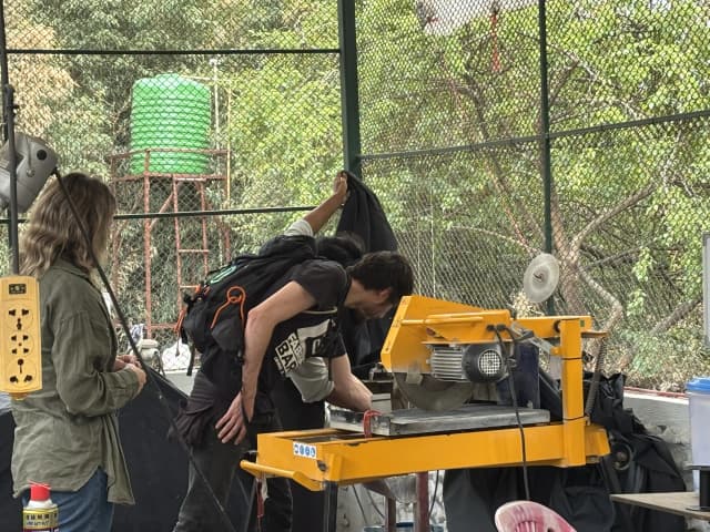 Mr. Miquel Cañada is touching the plastic melting machine at Moware workshop.