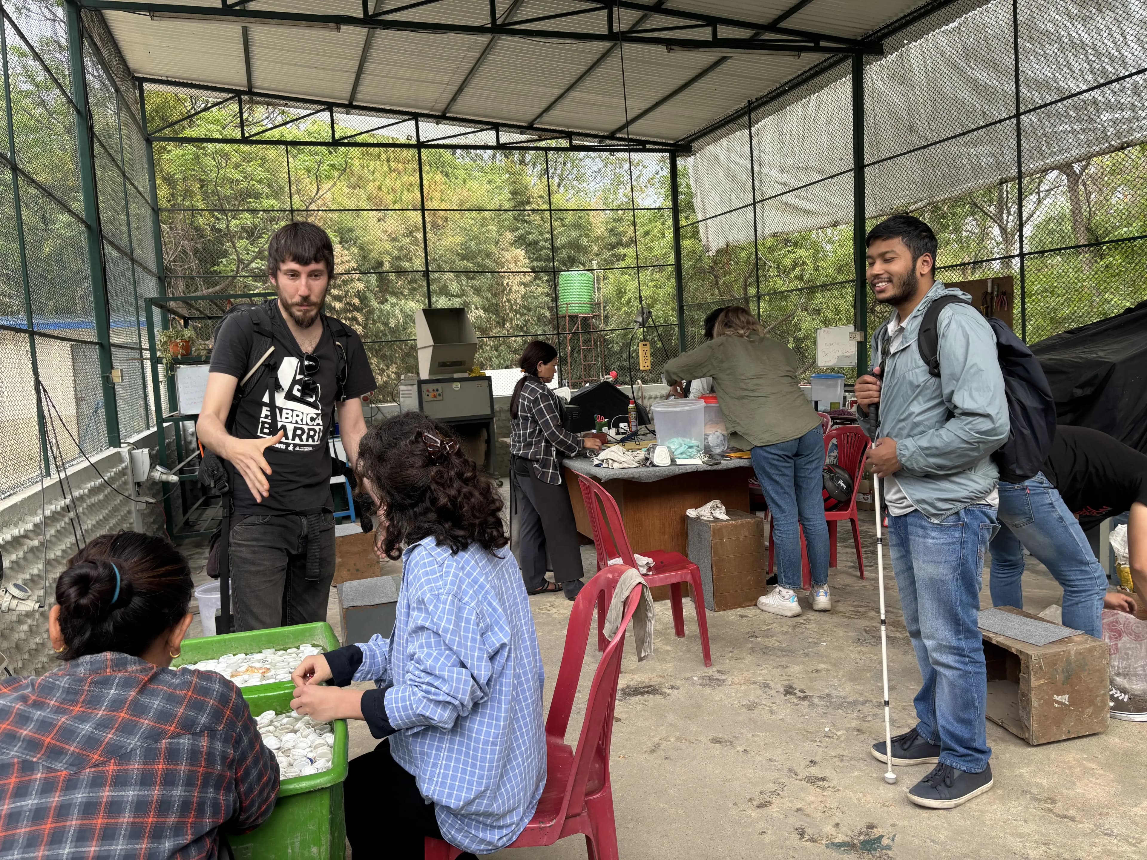Mr. Miquel Cañada is talking with one of the international interns at Moware. In the background, other workers are working and our Founder, Mr. Abhishek Shahi is smiling.