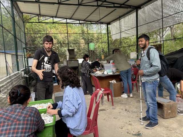 Mr. Miquel Cañada is talking with one of the international interns at Moware. In the background, other workers are working and our Founder, Mr. Abhishek Shahi is smiling.