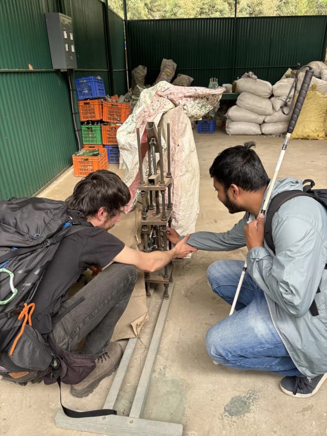 Our Founder, Mr. Abhishek Shahi is touching the plastic melting machine and Mr. Miquel Cañada is explaining about the machine to him.