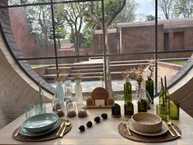 A picture where different product of Moware is displayed. There are vase, glass, candle stand, plates, and bowl.