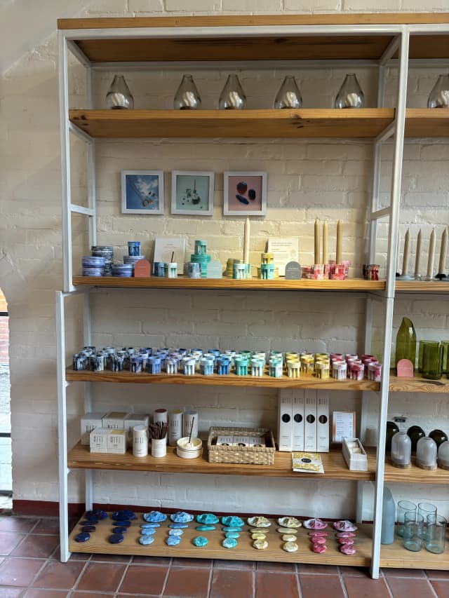A picture where different product of Moware is displayed. There are varieties of candle stand and miniature mountain ranges.
