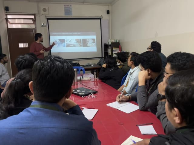 Mr. Miquel Cañada is pointing towards the slide and explaining it to the participants of the master class.