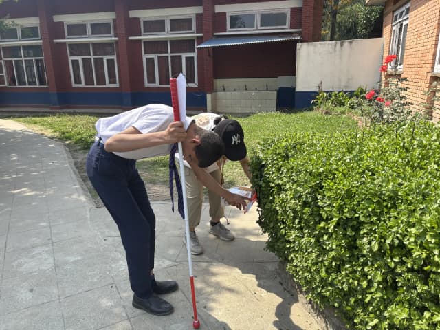 A pair of visual disability and his guide has spotted one of the checkpoint being hung in the tall grass of the orientation game.