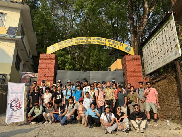 A group picture of around 42 individuals including project members, teachers and students with visual disabilities from Lab Schools, Spanish volunteers and facilitators, representative from Access Nepal and members of CFC. On the left, there is the banner of CFC and on top 'Shivapuri National Park' is written.