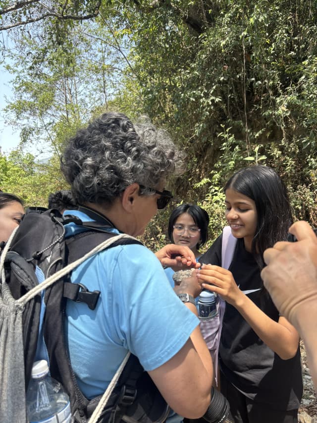 One of the facilitators, Mrs. Nuria Caus Pertegaz is letting one of the participants with visual disabilities to feel a stone and describing it to her.