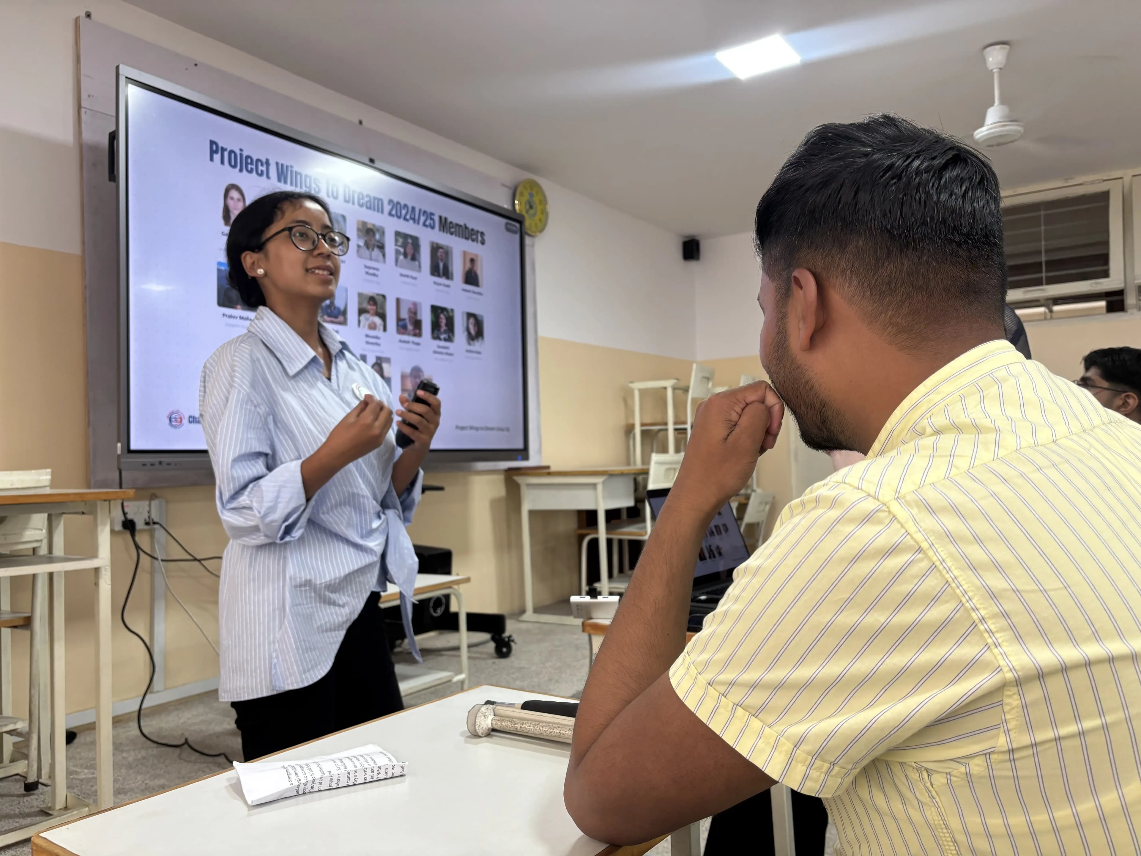 3D Design & Printing Officer, Ms. Garima Shakya is speaking. In the screen, “Project Members 2024/25” is written along with the pictures of each members.