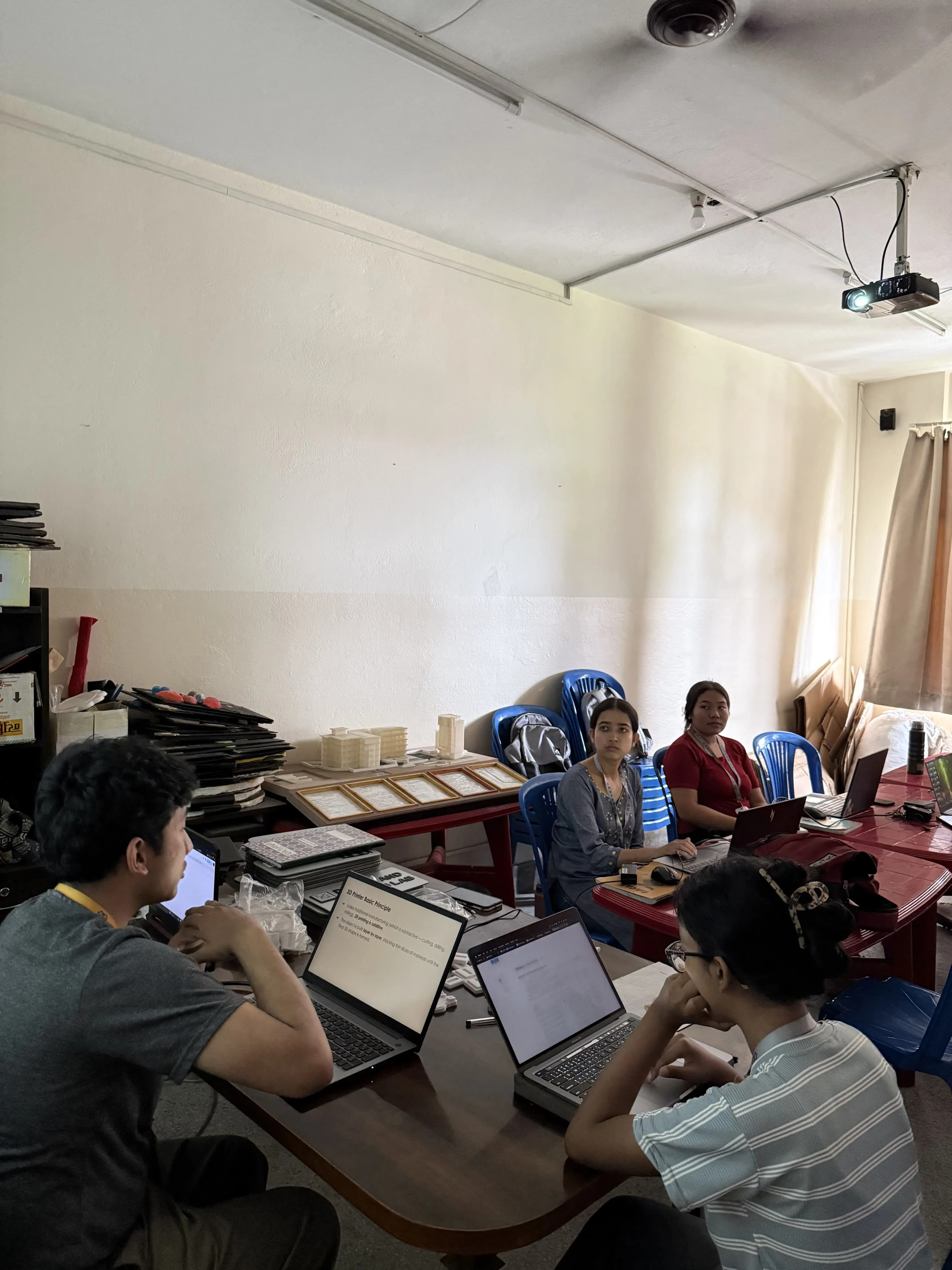 3D Design & Printing Officer, Ms. Garima Shakya and a member from computer team Mr. Aakash Shrestha is facilitating the new project members. Two of the new members from computer department is observed in the picture.