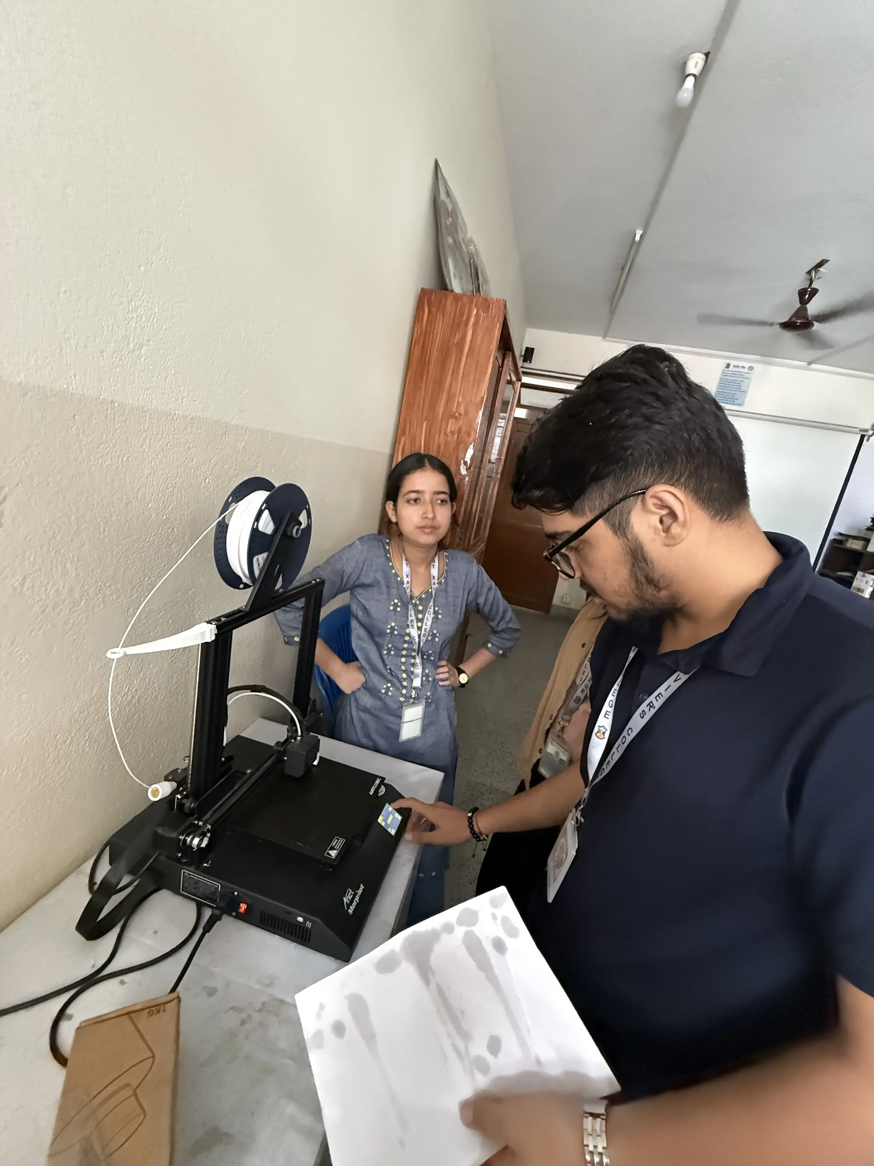 Two of the new project members are observed using 3D FDM printer. Mr. Prabin Bhattarai is operating the printer and Ms. Arpana Basnet is observing him.