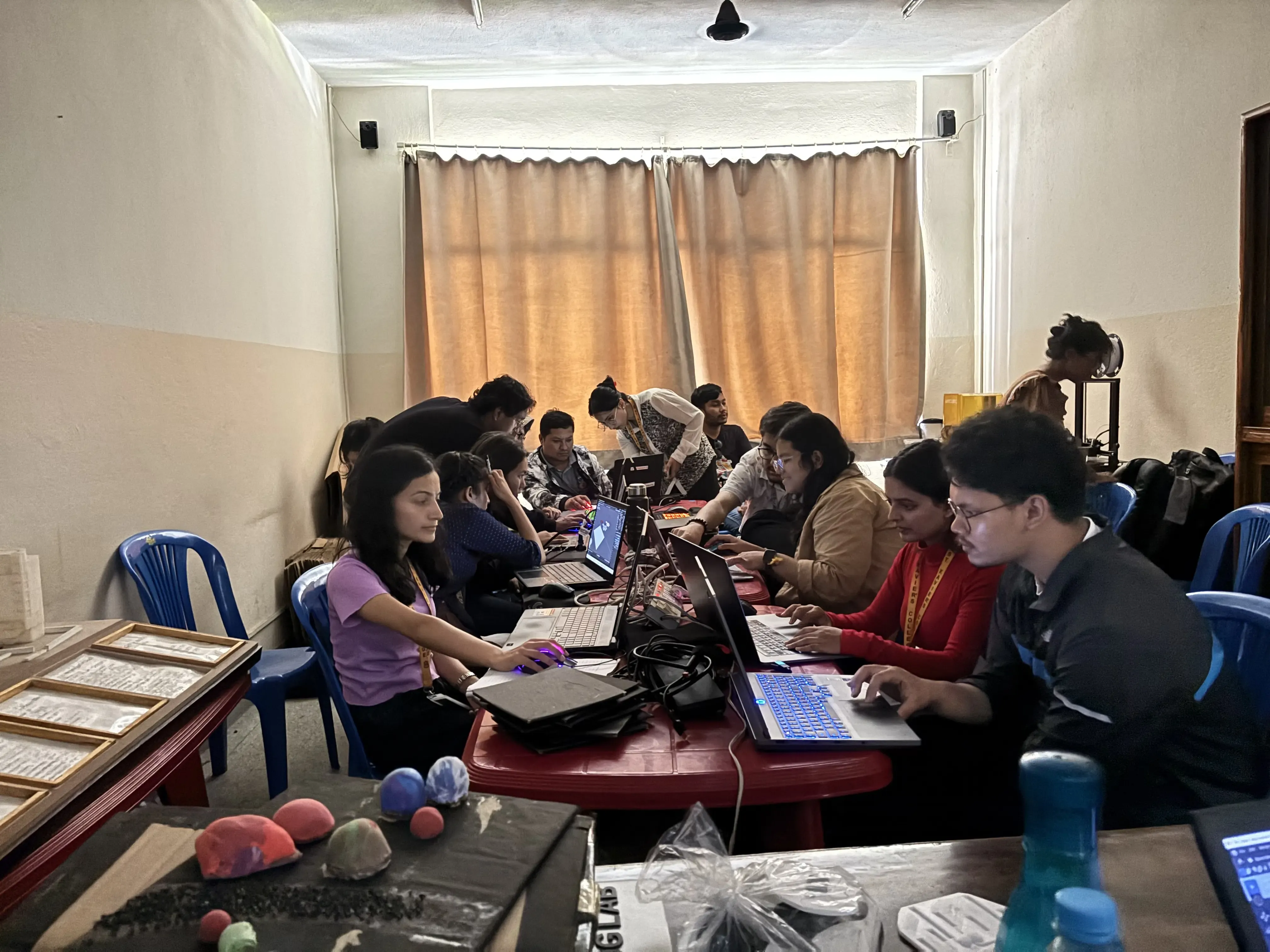 Around 8 participants including the staffs from St. Xavier's College and project members are observed. Two of the project members (2024/25) from Computer Department are supporting the participants. Even, the Founder & President, Mr. Abhishek Shahi and 3D Design & Printing Officer is observed in the background.