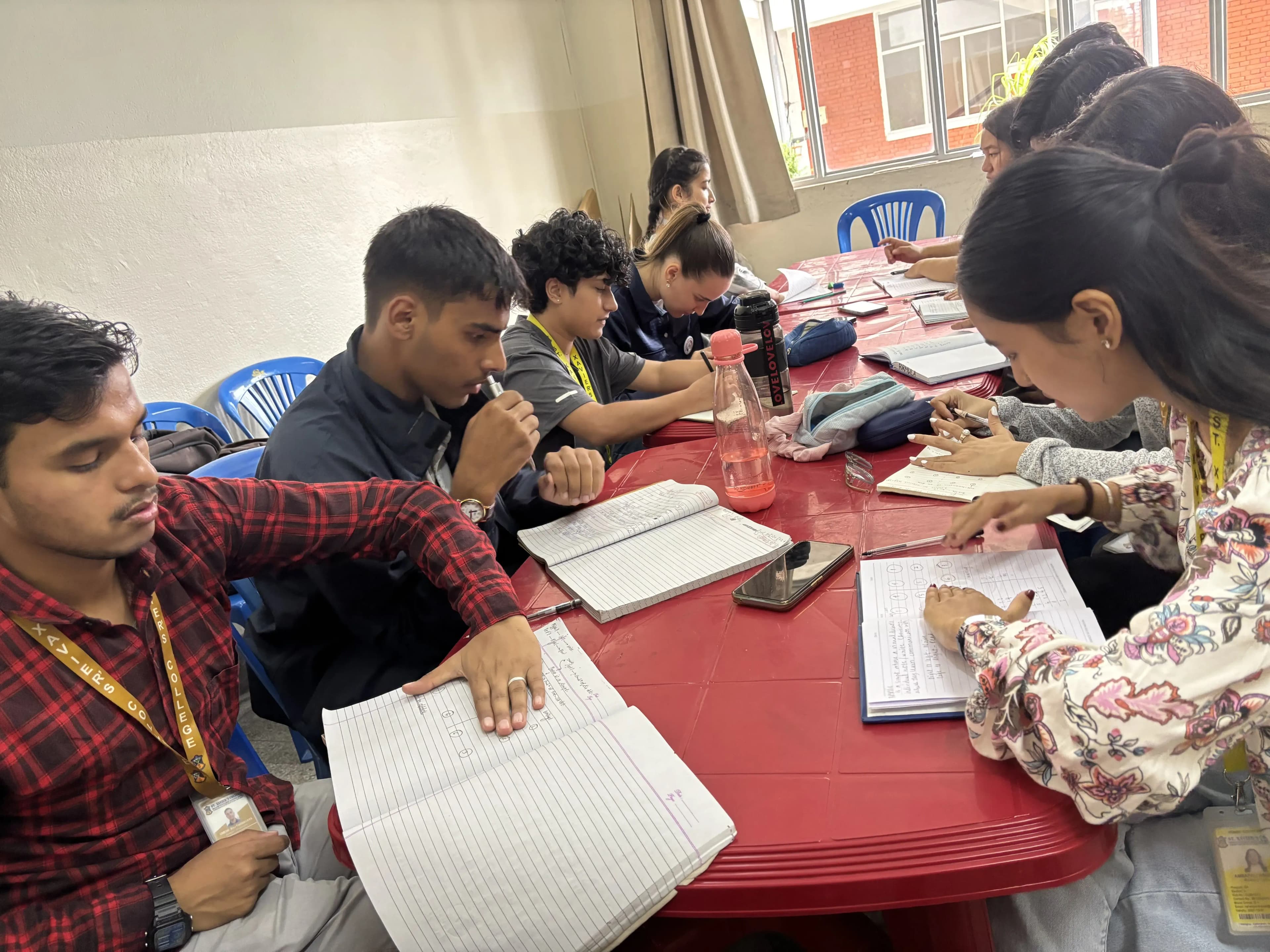 All the participants are engaged in an interactive task where they are using their hands to cover the selective circle that is assumed to be  6 braille dots in their notebook.