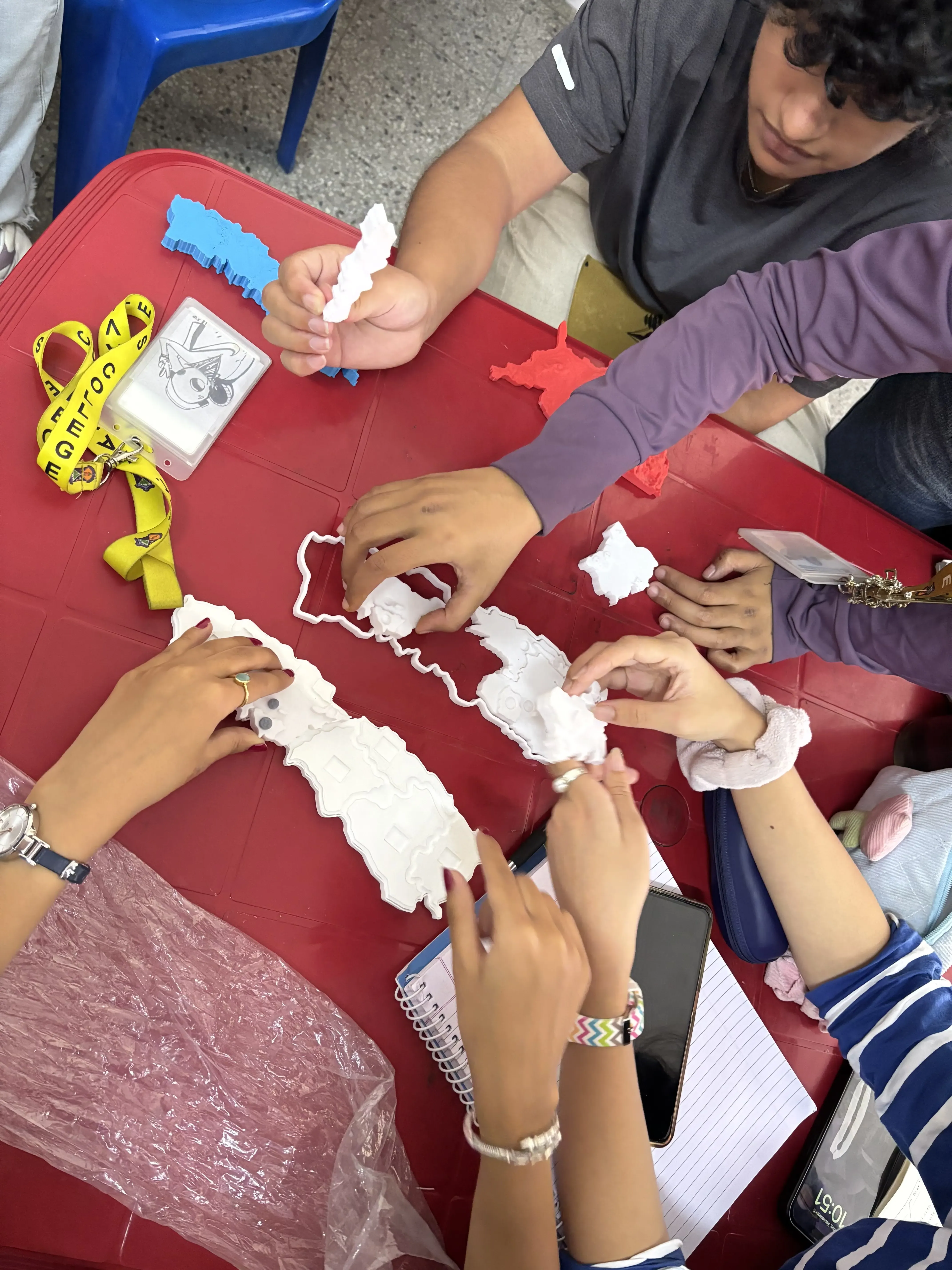 Close up of participants hands exploring the 3D models of Map of Nepal.