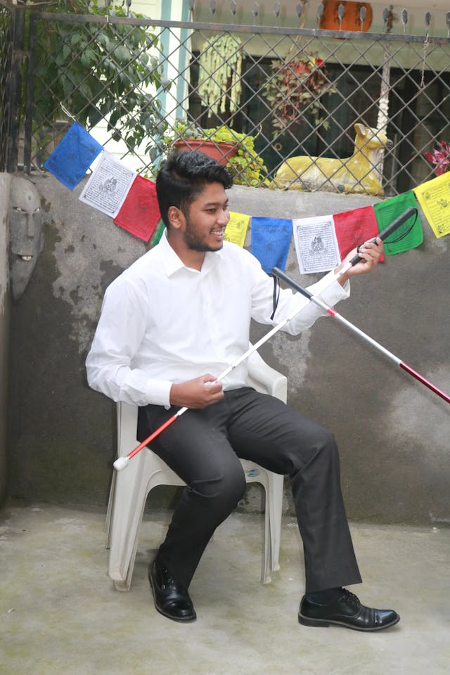 Portrait of our Founder and Director Mr. Abhishek Shahi posing with a white cane.