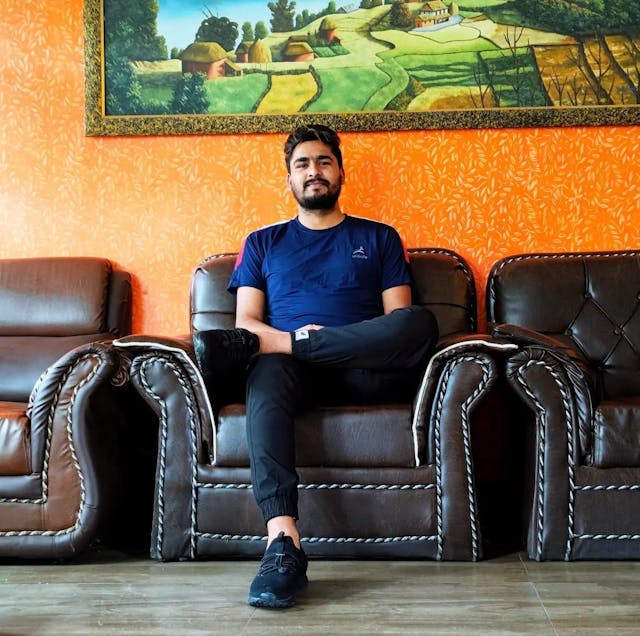 Our Life-time Member Pradip Raj Pokharel sitting on a sofa.