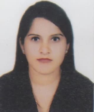 Young woman with light-brown skin and straight dark hair parted to one side, wearing a dark top and small stud earrings, facing the camera with a neutral expression against a plain white background.