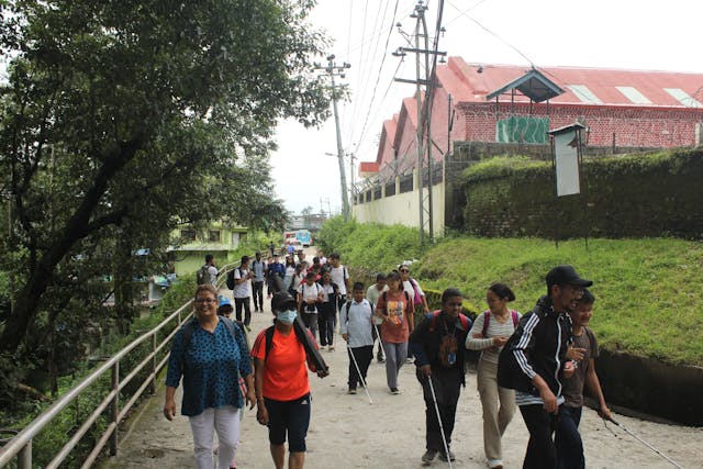 Participants with visual disabilities and their guides along with the teachers of Laboratory School starting their hike to Sundarijal Shivapuri Nagarjung National Park.