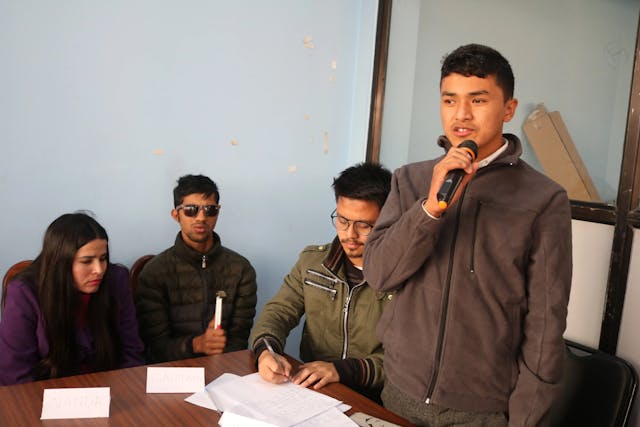 The image contains, 4 participants discussing in a group in the event of panel discussion on the general overview of disability laws in Nepal.