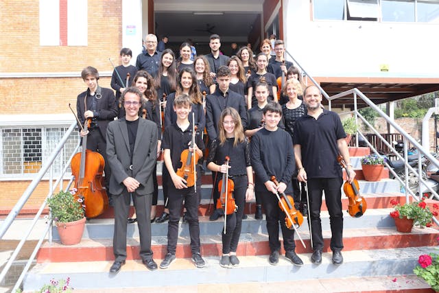 Around 23 - 26 members of Segon Temps – the orchestra band are posing in the staircase of Watrain hall of St. Xavier’s College, Maitighar after performing at the Abhilasha – The Charity Orchestra Concert in Nepal.