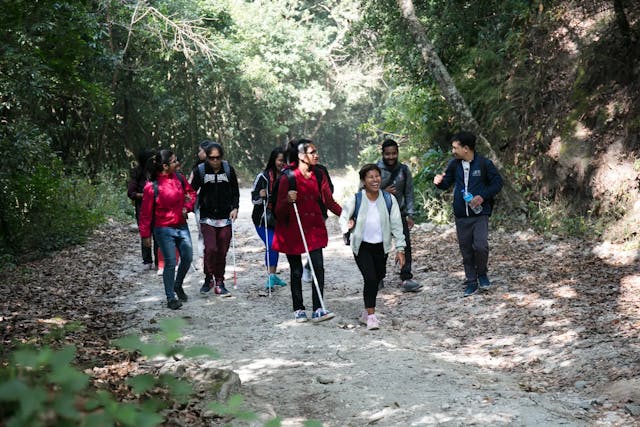This is a photograph of hikers with visual disabilities along with their pair who are being guided through the hiking route of Shivapuri Nagarjung National Park.