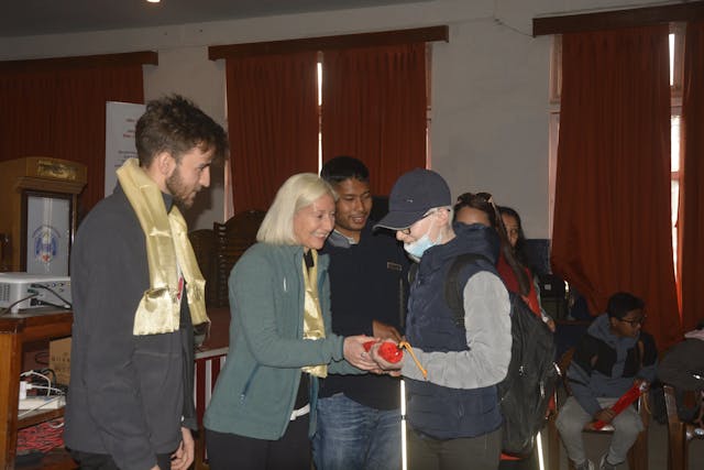 Dr. Cristina Gomez Vicente is presenting white cane to one of the participants with visual disabilities and Dr. Guillermo Rodriguez Cortes & Abhishek Shahi (Founder & President of Chain For Change) is observed in the background.